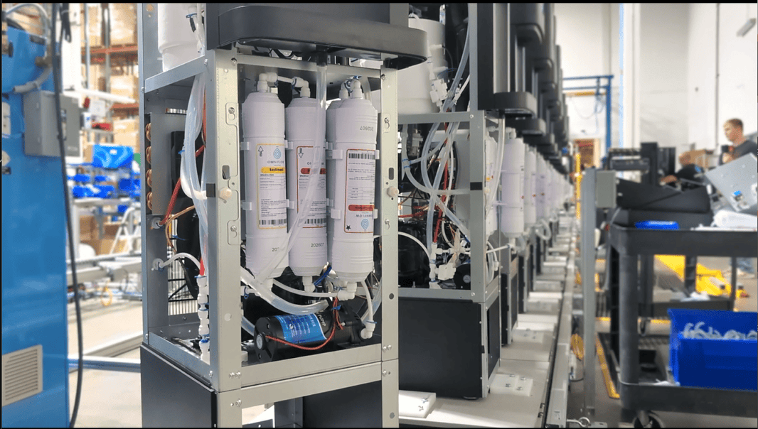 Bottleless Nation water unit on the manufacturing line, showing the purification system inside