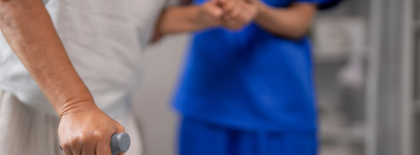 Nurse helping an old person walk.