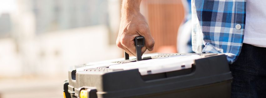 Person holding a tool box.
