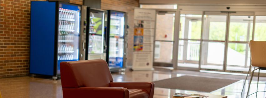 Lobby of a building with vending machines.