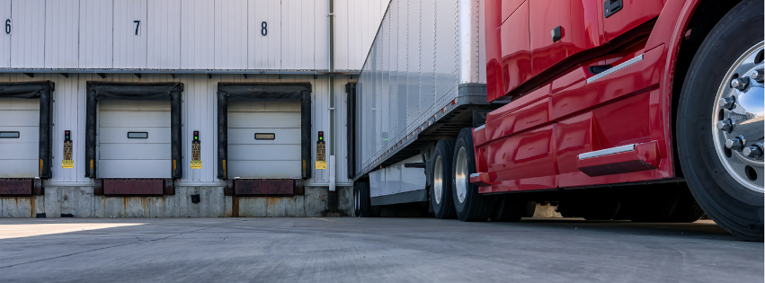 Semi-truck parked at a dock.