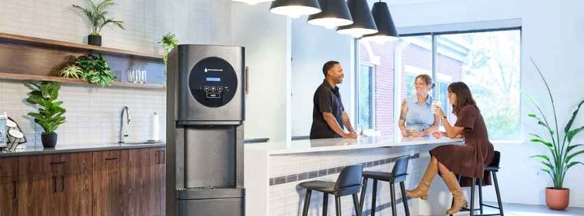 Employees conversing next to a Bottleless Nation water and ice machine