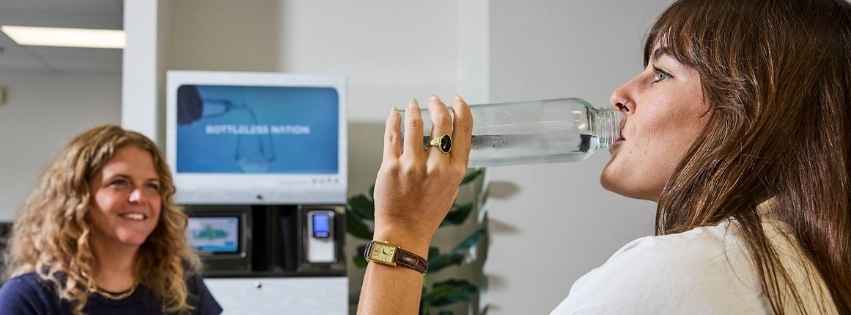 Employees drinking water next to a Bottleless Nation Sparkling Water Machine